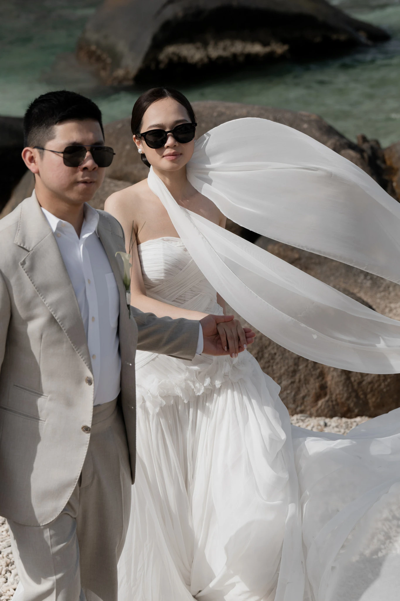 Linh và Bình bên biển với khăn voan bay trong gió.